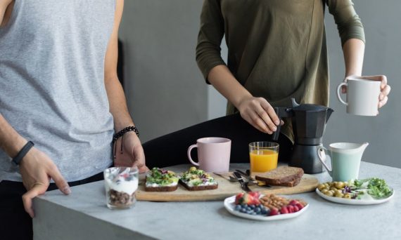 Cozy morning breakfast with avocado toast, coffee, and fresh juice.